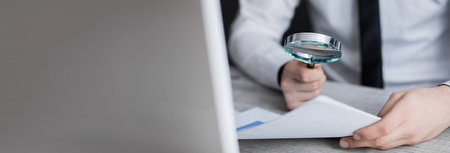 man hand magnifier and document in office deskの写真素材
