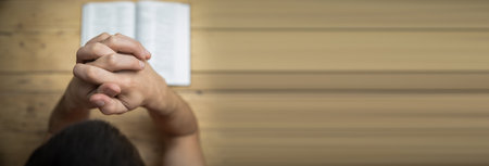 Man hand Bible on wooden background