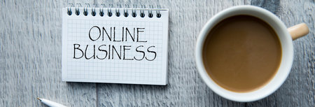 Online business text on notepad with coffee on tableの写真素材