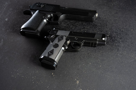 Two guns on black table, criminal conceptの写真素材