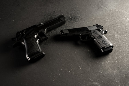 Two guns on black table, criminal conceptの写真素材