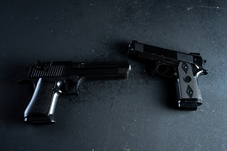 Two guns on black table, criminal conceptの写真素材