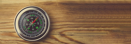 Compass on wooden table background
