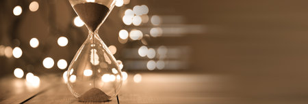 Hourglass on the lights bokeh background