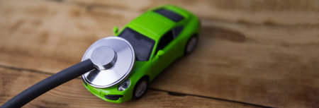 Stethoscope and car on the wooden tableの写真素材