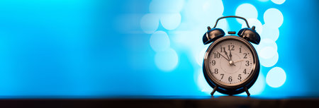 clock on bokeh on blue backgroundの写真素材