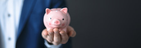 man hand holding piggy bankの写真素材