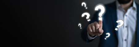 man touching question mark in screenの写真素材