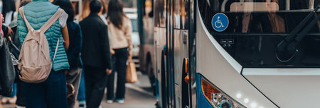 People get into public transport at a bus stopの写真素材