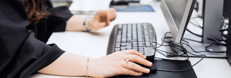 Office worker sitting in front of a computer works