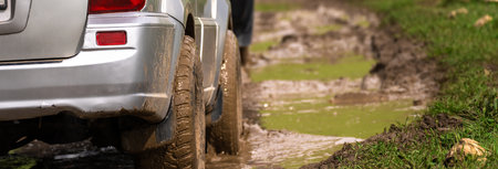 Cars drive through mud during the day
