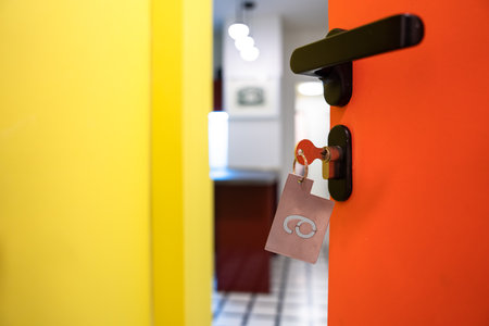 hotel room door half open, orange and yellow design, service industry concept