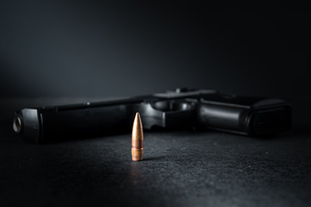 Gun bullet and gun on the table, criminal concept