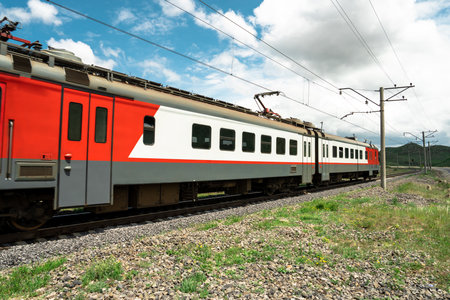 red train on railway track in nature, travel concept