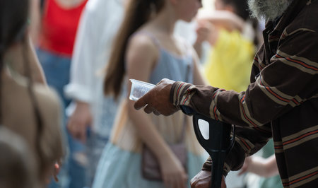 Beggar old man is begging for moneyの写真素材