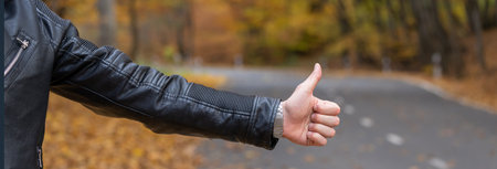 A man stops a car in the forest in autumn