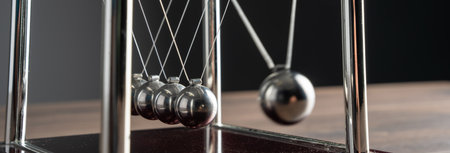 Harmony in Motion: Newton's Cradle Demonstrates the Beauty of Physicsの写真素材