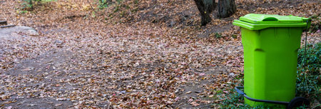 Big green trash can in the forest, concept of environmental protectionの写真素材