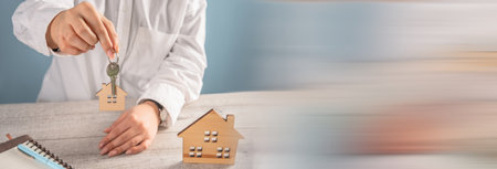 House keys in woman's hand, concept of home buying and selling serviceの写真素材