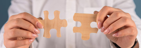 Woman Skillfully Joins puzzle Wooden Pieces, Symbolizing Problem Solving and Progressの写真素材