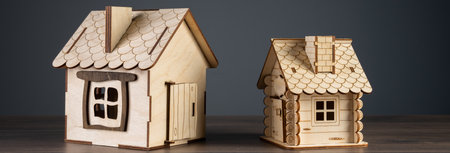 Wooden houses on gray background, home buying and selling conceptの写真素材