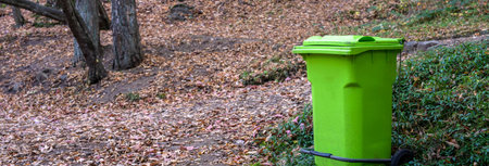 Big green trash can in the forest, concept of environmental protectionの写真素材