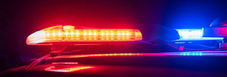 Red and blue lights of a police car at night close up. stock photoの写真素材
