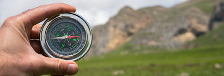 Travel compass in traveler's hand, mountain viewの写真素材
