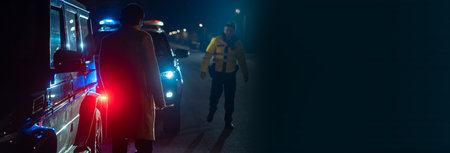 police officer stands next to a car he pulled over for speeding, reaching for the driver's ID, stock photoの写真素材