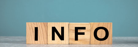 The words info written on wooden cubes, in the background of the blue studio:の写真素材