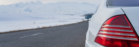 White car on asphalt road in winter, winter travelの写真素材