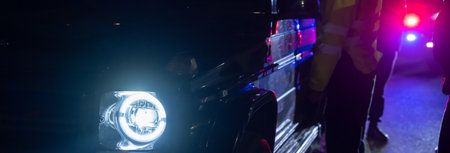 police officer stands next to a car he pulled over for speeding, reaching for the driver's ID, stock photoの写真素材
