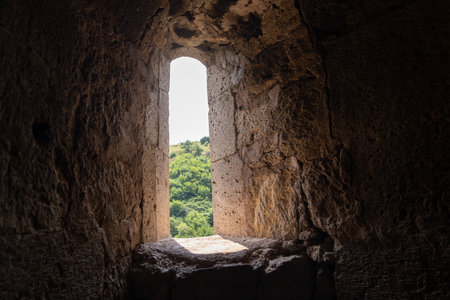 Light streaming through the window of an old stone castleの写真素材