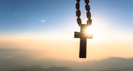Wooden cross on the background of sunset, sunlightの写真素材