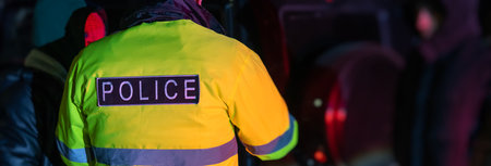 A police officer stands with his back to the car he stopped for speeding. stock photoの写真素材