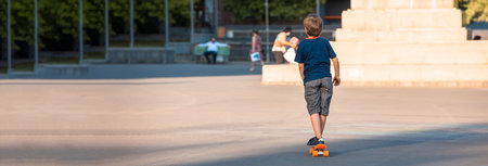 A kid riding a skateboard in a crowded place in the city. stock photoの写真素材