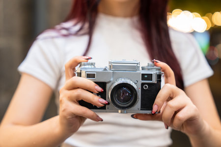 The camera in the hands of a young girl, aesthetic, photography conceptの写真素材