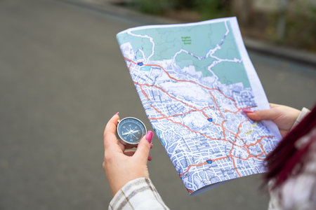 Girl holding map and compass, travel