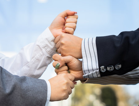Business team with fists together, togetherness, team spirit, cooperation, business concept