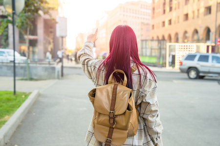 Tourist girl with shoulder bag navigating the cityの写真素材