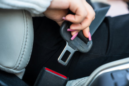 Female driver fastening seat belt, safety rulesの写真素材