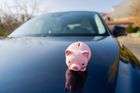 The piggy bank on the hood of the carâ¤Saving money to buy a carの写真素材