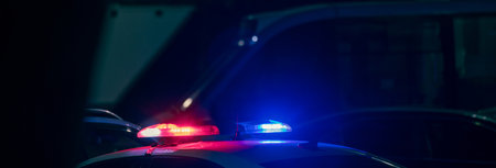 Red and blue lights of a police car close up in the evening, stock photo