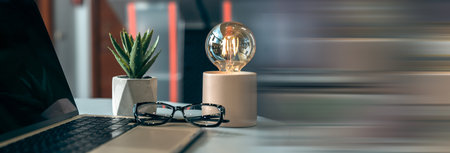 Office desk with laptop on it, glasses, decor, business concept, stock photo
