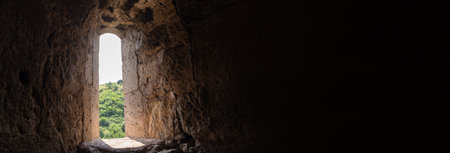 Light streaming through the window of an old stone castleの写真素材