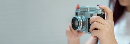 The camera in the hands of a young girl, aesthetic, photography conceptの写真素材