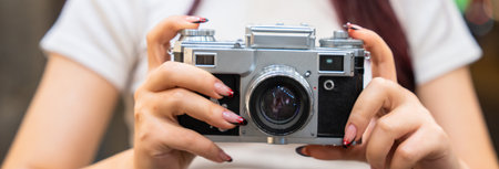 The camera in the hands of a young girl, aesthetic, photography concept