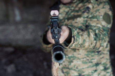 Mercenary Holds Gun, Prepared for Questioning