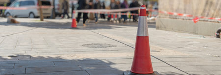 traffic sign that says SLOW at a roadway construction site. Bright traffic cones