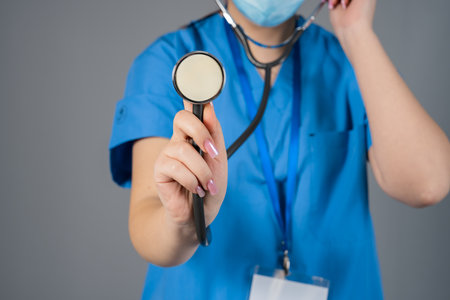 Doctor Holding Pharyngoscope, Pointing at Cameraの写真素材